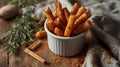 Golden-brown cinnamon-dusted sweet potato fries fill a white ceramic rameki Royalty Free Stock Photo