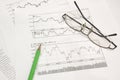 Stock graphs, pencil and glasses Royalty Free Stock Photo