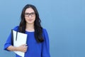 Stock image of female college student isolated on blue background Royalty Free Stock Photo