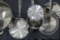 Stainless steel pots and pans hanging in the kitchen Royalty Free Stock Photo