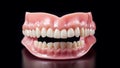 A set of upper and lower dentures. Dental prosthesis with gum in a plain surface. Royalty Free Stock Photo