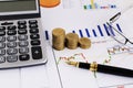 Stock invester concept with business fountain pen and coins stack and eyeglasses and calculator Royalty Free Stock Photo