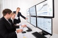 Stock Market Brokers Looking At Graphs On Multiple Computer Royalty Free Stock Photo