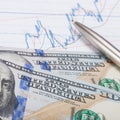 Stock market graph with pen and hundred dollars banknote - close up Royalty Free Stock Photo