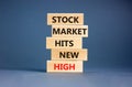 Stock market hits new high symbol. Concept words Stock market hits new high on wooden blocks on a beautiful grey table grey Royalty Free Stock Photo