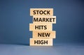 Stock market hits new high symbol. Concept words Stock market hits new high on wooden blocks on a beautiful grey table grey Royalty Free Stock Photo