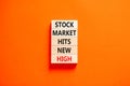 Stock market hits new high symbol. Concept words Stock market hits new high on wooden blocks on a beautiful orange table orange Royalty Free Stock Photo