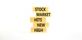 Stock market hits new high symbol. Concept words Stock market hits new high on wooden blocks on a beautiful white table white Royalty Free Stock Photo