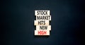 Stock market hits new high symbol. Concept words Stock market hits new high on wooden blocks on a beautiful black table black Royalty Free Stock Photo