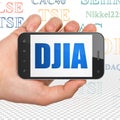 Stock market indexes concept: Hand Holding Smartphone with DJIA on display Royalty Free Stock Photo