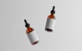 Amber Glass Dropper Bottle Mockup - Two Floating Bottles. Blank Label. 3D Illustration