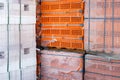 Stock pallets of red bricks wrapped in stretch film at wholesale outdoor market ot store. Construction site with prepared Royalty Free Stock Photo