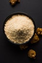 Stock Photo of Asafoetida powder / Hing or Heeng with cake and mortar Royalty Free Stock Photo