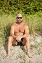 Stock photo bald beard man on the beach dunes