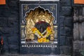 Stock photo of beautiful small temple of lord ganesha engraved on the wall painted with black color. clay made oil lamp near the Royalty Free Stock Photo