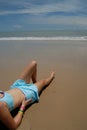 Stock photo of beautiful tall brunette woman on the beach in the