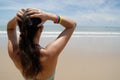 Stock photo of beautiful tall brunette woman on the beach in the