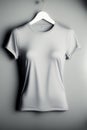 Stock photo of a blank light gray female fitted t-shirt blank, hanging on a hanger