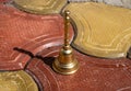 Stock photo of carved designer copper or bronze bell or hand bell used for worshiping god in hindu temples. bell kept on floor