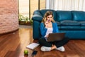 Woman sitting on floor with laptop