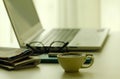 Stock Photo - Coffee, newspapers and laptop in soft focus setting with dramatic ambient light