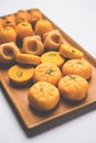 Stock photo of collection of variety of sweets or orange peda or pedha or pera made up of milk, khoya, sugar , saffron etc. select