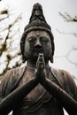 Stock photo depicts a bronze statue of the Buddha