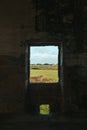 Abandoned and Decaying Building in Southern Italy: View Through Window Hole to Beautiful Italian Countryside