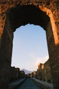 an arch in the middle of an ancient street in pompei, italy Royalty Free Stock Photo