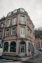 Classic Corner Building in Dinant, Belgium with Retail Storefront Royalty Free Stock Photo