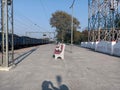stock photo features a railway platform with white - red-colored wooden benches for passengers.