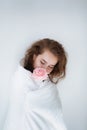 Flirty sexy girl with a white blanket in her bedroom.