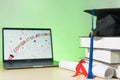 Stock photo of a graduation cap mortar board with books and diploma certificate isolated on wooden table against RGB color Royalty Free Stock Photo