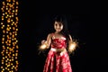 Stock photo of indian little girl holding fulzadi or sparkle or fire cracker on diwali night Royalty Free Stock Photo