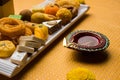 Indian sweets or Mithai for diwali festival with oil lamp or diya and gift box Royalty Free Stock Photo