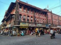 Stock photo of Kolhapur Municipal Corporation building, small commercial shop at the ground floor, street vendor near the building