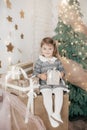 Little beautiful girl near the festive christmas tree Royalty Free Stock Photo