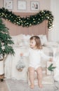 Little beautiful girl near the festive christmas tree Royalty Free Stock Photo