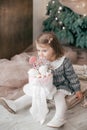 Little beautiful girl near the festive christmas tree Royalty Free Stock Photo