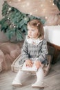 Little beautiful girl near the festive christmas tree Royalty Free Stock Photo