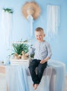Little boy play with gosling indoors in spring