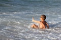 Little boy play with waves Royalty Free Stock Photo