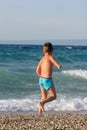 Little boy play with waves Royalty Free Stock Photo