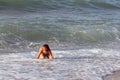 Little boy plays in sea