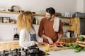 Couple preparing food in kitchen. Royalty Free Stock Photo