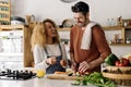 Couple preparing food in kitchen. Royalty Free Stock Photo