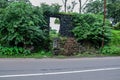 Stock photo of old collapsed wall constructed using black stone road side of Indian village area, picture captured during rainy Royalty Free Stock Photo