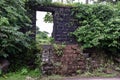 Stock photo of old collapsed wall constructed using black stone road side of Indian village area, picture captured during rainy Royalty Free Stock Photo