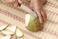 Stock Photo - Peeling coconut.