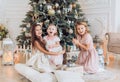 Portrait of three beautiful girls sisters in Christmas decorations Royalty Free Stock Photo